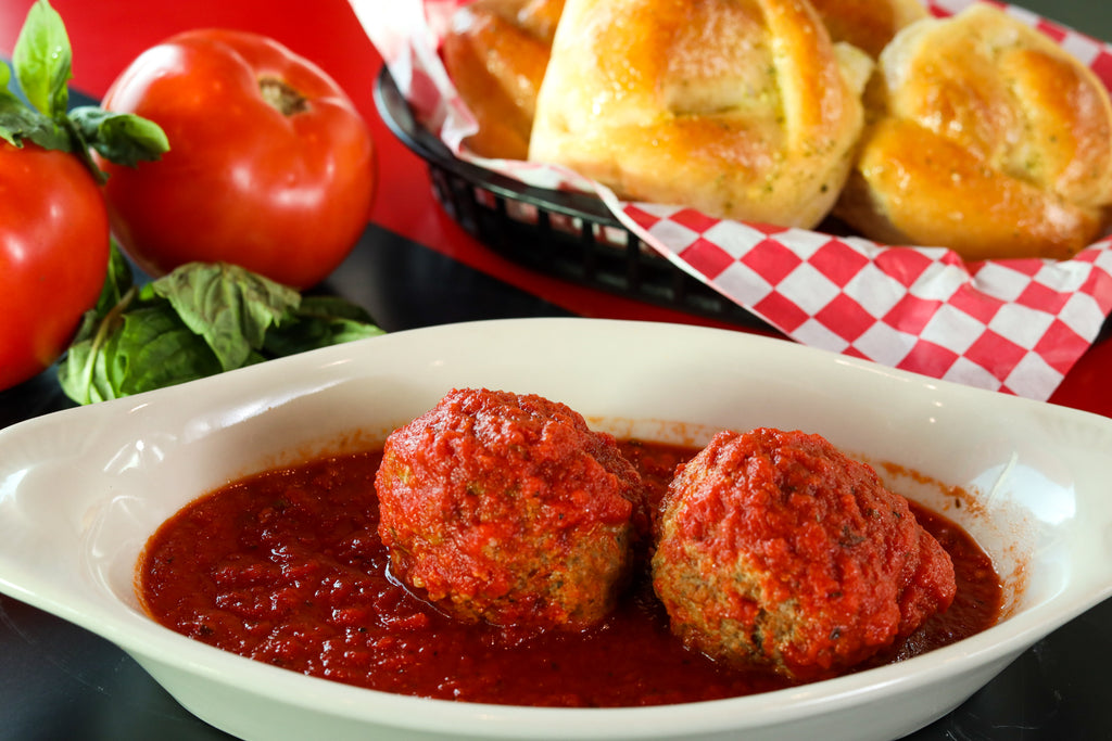 Homemade Italian meatballs in marinara sauce served as a savory side dish at our family-style Italian restaurant.